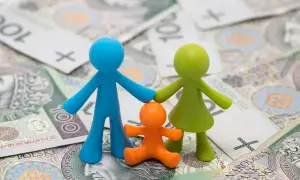 Figurki symbolizujące rodzinne szczęście na tle polskich banknotów.